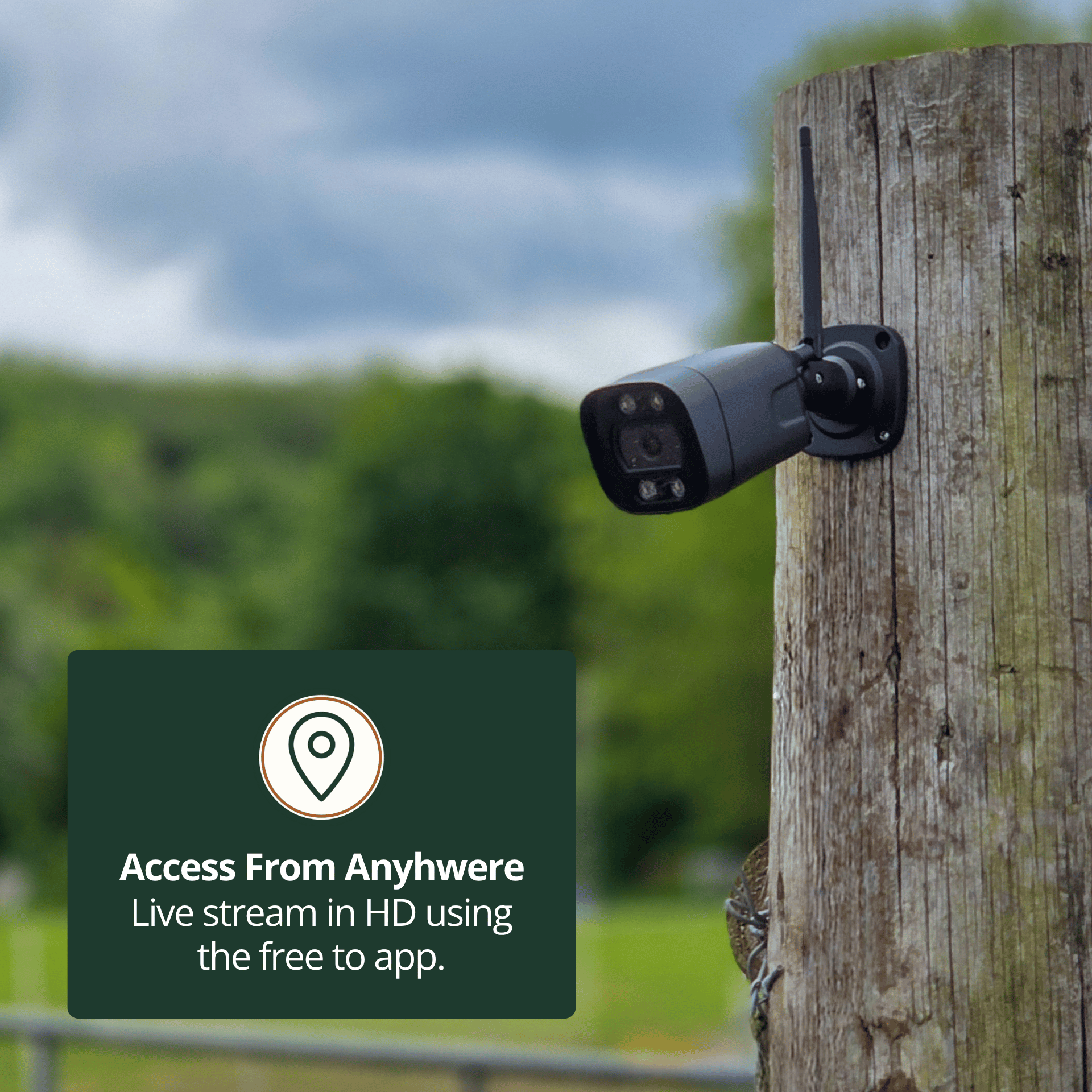 RuralView Bullet camera on a wooden post overlooking a field, illustrating remote viewing through the phone app.